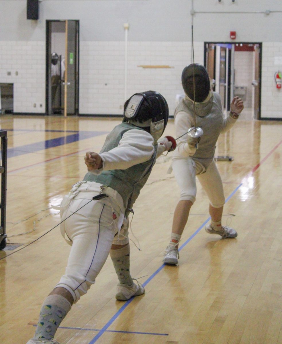 South Campus student Isaac Senisch and dual-credit student Persephone Battle practice a bout, a single fencing match. 