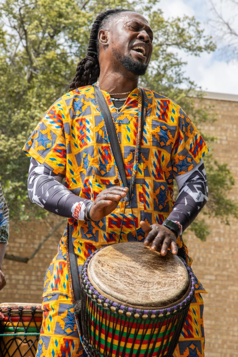 Bandan Koro member Edward Dogbe bangs out a rhythm on the djembe.