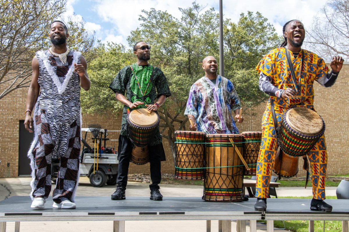 Members of the Bandan Koro group perform a call and response with people participating in the the International Festival.