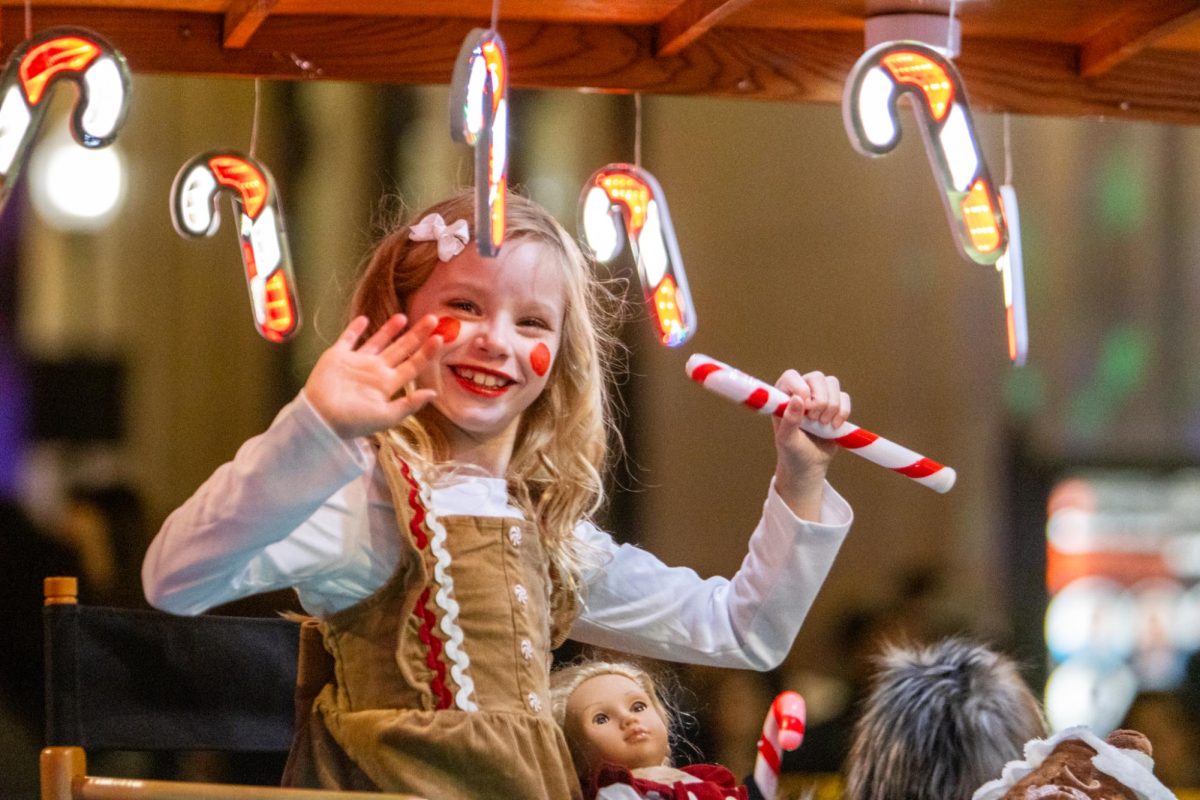 The Fort Worth Model A Ford Club had multiple cars all decked out in lights including one decked out in candy canes with a gingerbread girl in the back waving to the crowds.