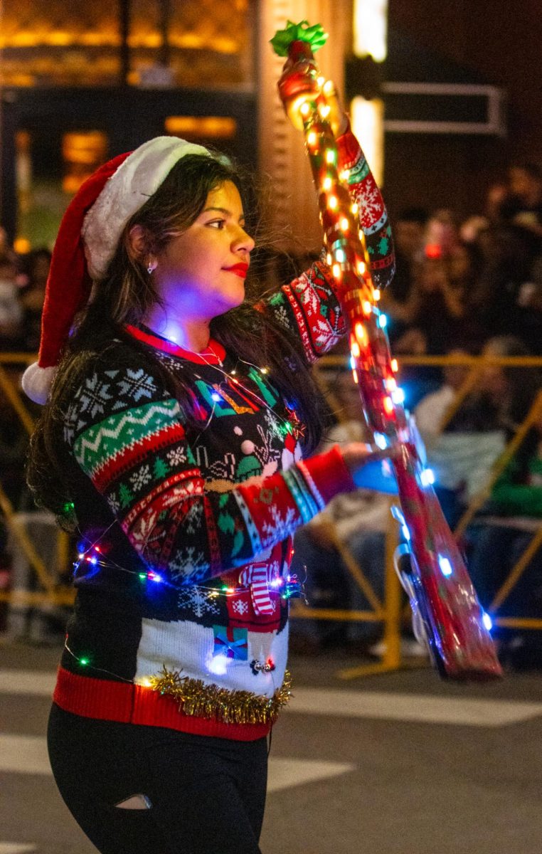 Many color guard teams were at the parade including South Hills High School color guard team in matching holiday sweaters.