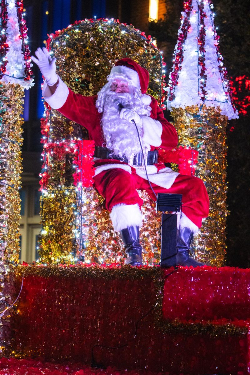 Santa Claus waves at people at the end of the Parade of Lights procession.