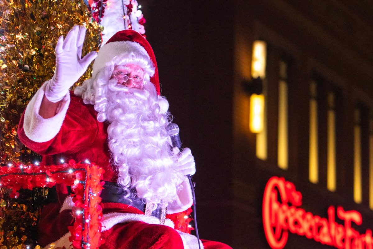 At the end of the more than 100 float parade, Santa Claus waves to parade goers wishing them a happy holidays.