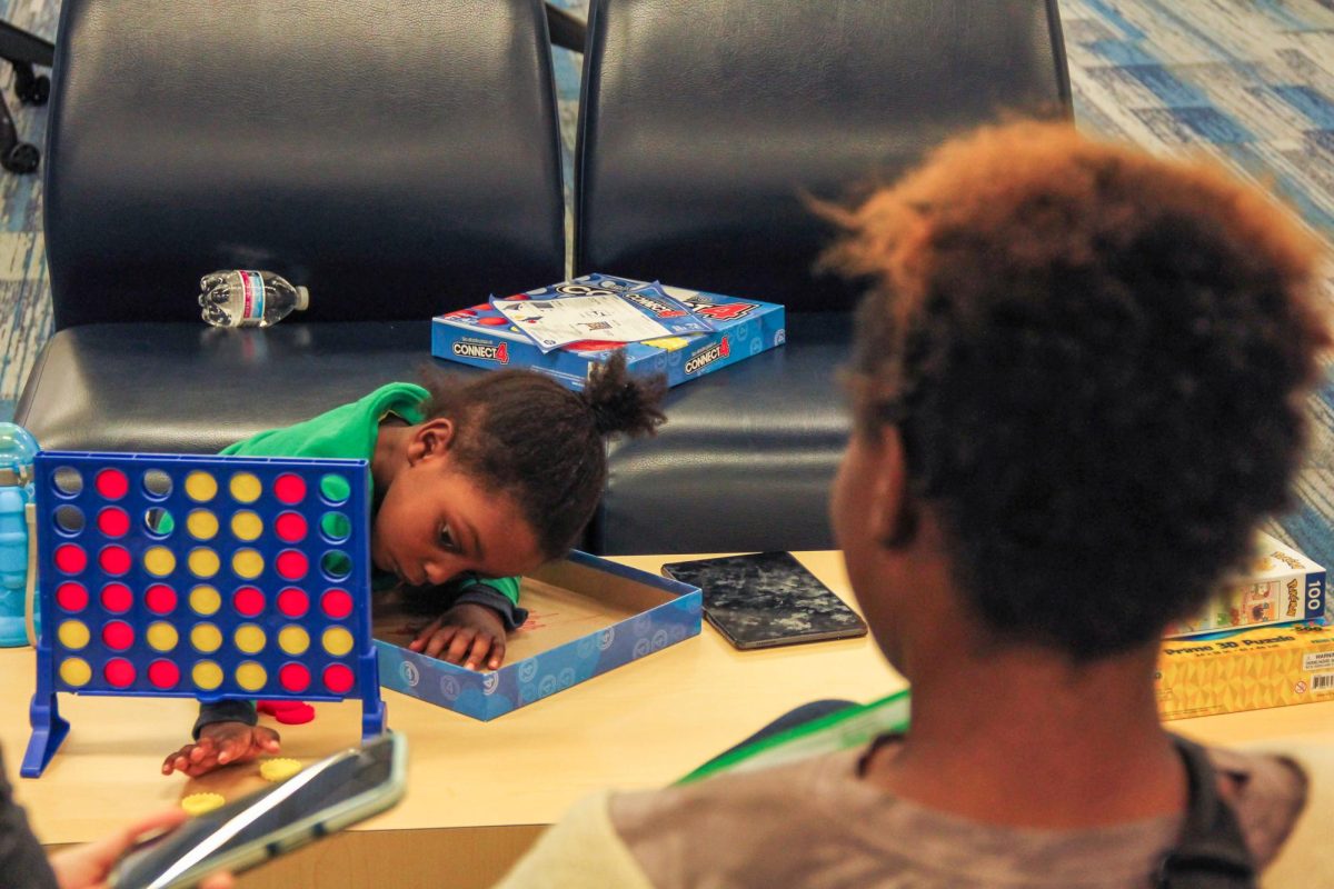 New Heights student Ancharnita Hunter waits between her classes with her 3-year-old son Tyme Hunter.