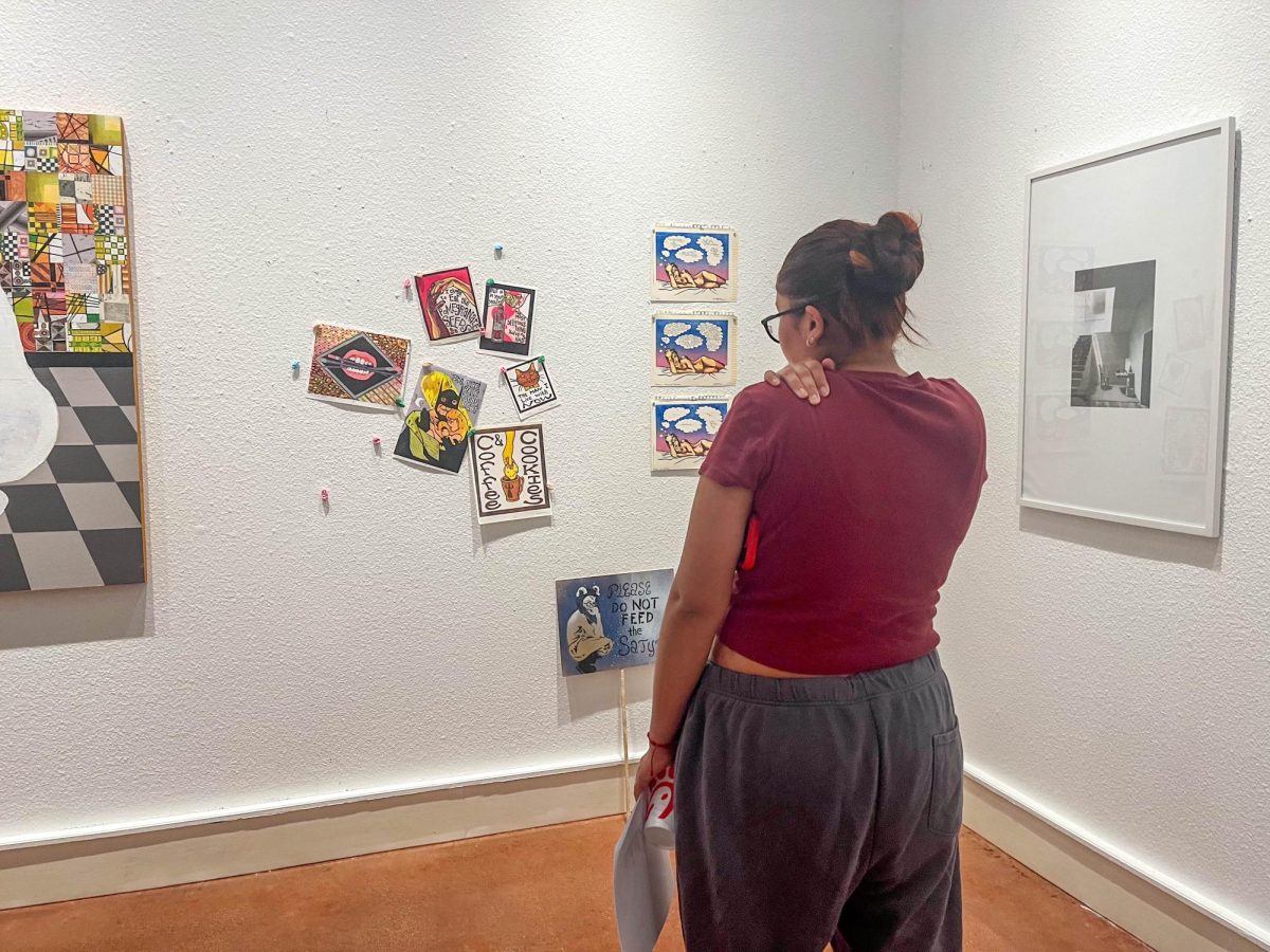 South student Nicole Narvaez looks at collection of prints done by her instructor, Courtney Googe.