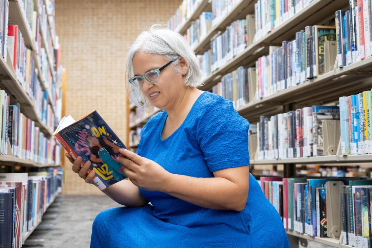 NE English associate professor Rebecca Balcarcel reads through the young adult novel she wrote called "Shine on Luz Véliz."