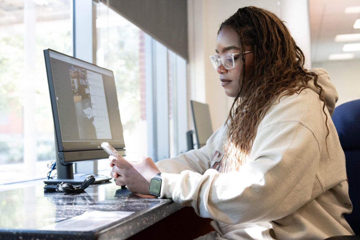 TR student Deja Burt edits an Instagram video in the library for a campus secret agent series she works on called "Toro Too and Deja Vu" where interviews students about campus life and student culture. 