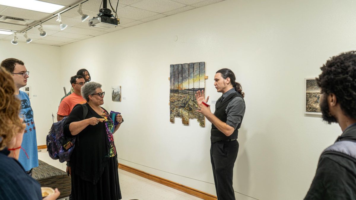 Artist Mathew Jones (to the right) talks about the process for his wax artwork inspired by Darthmore National Park