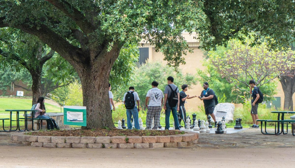L.D. Bell High School students gather at the giant chessboard on the NE Campus lawn before their classes begin. 