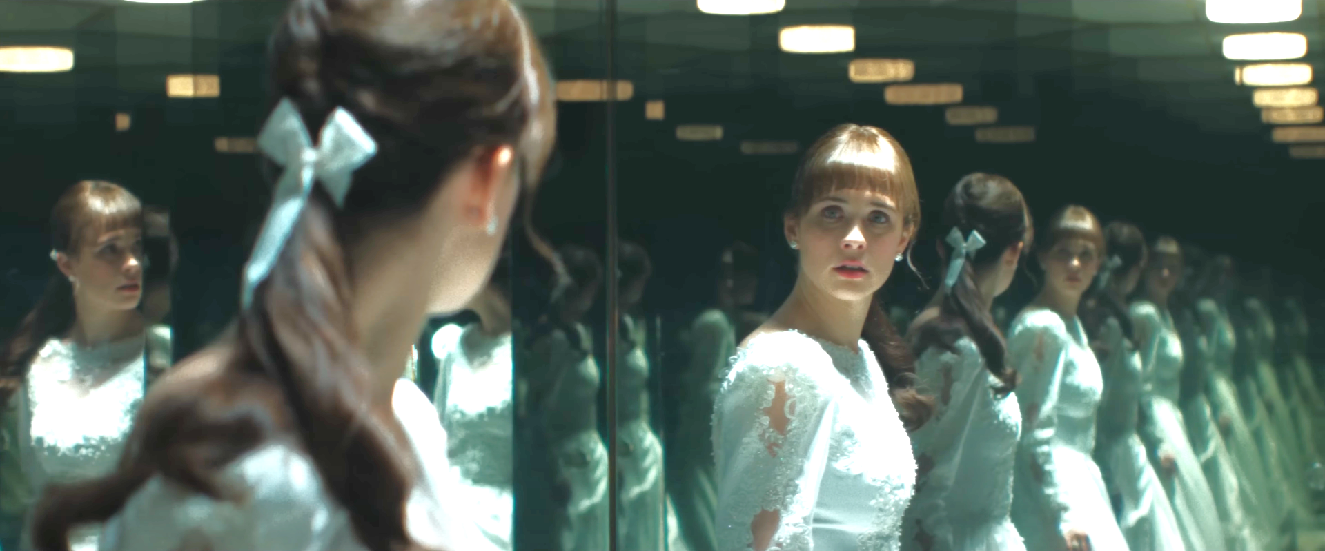 Judy Warren, played by Mia Tomlinson, looks into dressing room mirrors while trying on wedding dresses and sees the demon that is haunting her family.