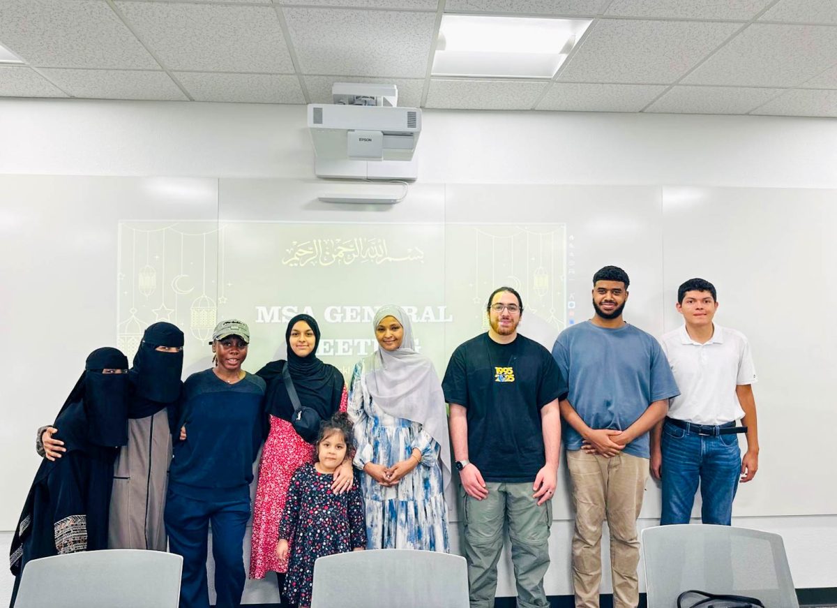 Members of the club pose beside with 
adviser Hind Ahmed after meeting.