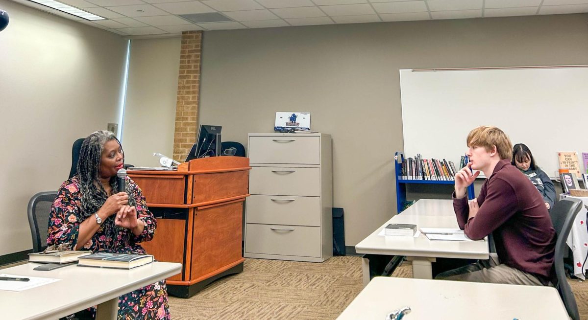 Author Yvonne Battle-Felton shares her experience with character development in her stories with NE student Teague Jackson.
