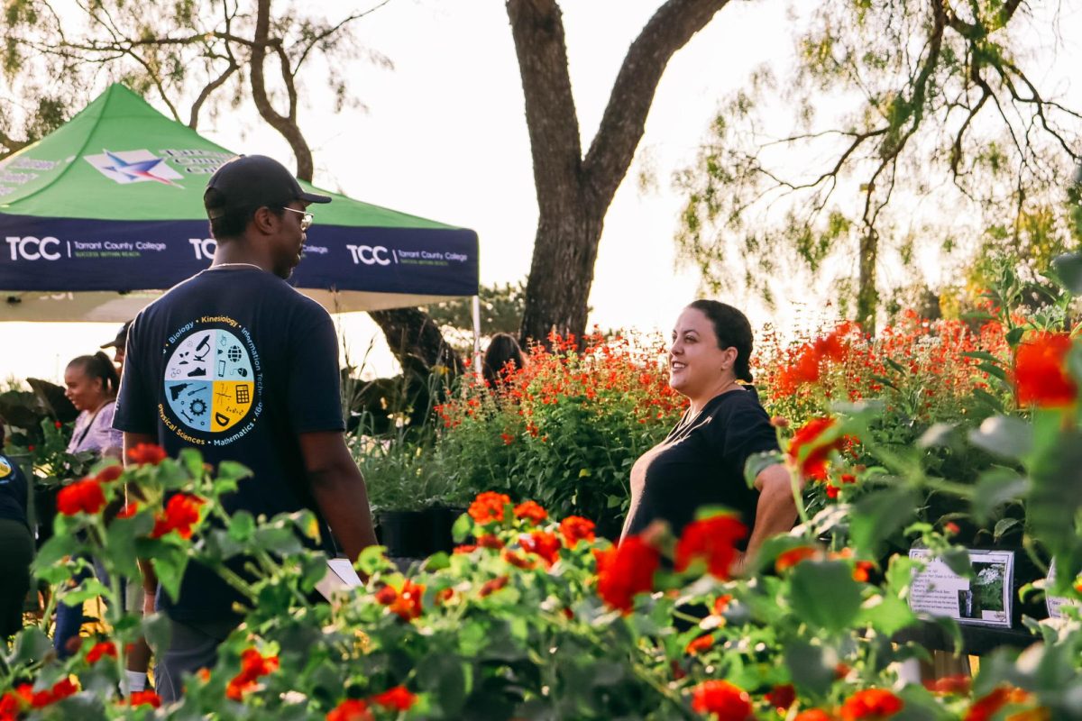 The NW horticulture lab manager Cameron Grant (left) and former horticulture student Ashlei Lucas (right) catch up while more people start to arrive. 