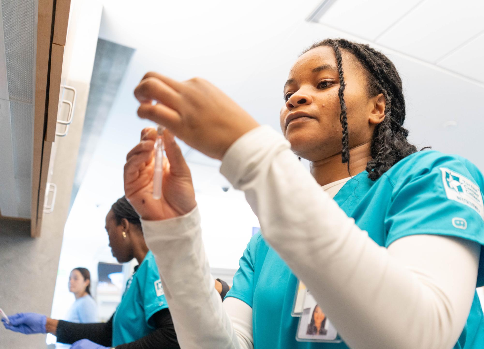 TR Nursing student Synthia Mulemaryabo learns how to perform IV insertion on an arm model at a lab in TRHN on Oct. 28.