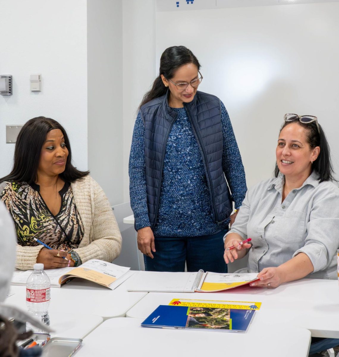 NE student Gloria Martinez tells teacher Mayra Mancera and student Fathy Ngindi that she is proud to learn and practice English in a pronunciation class Jan. 30