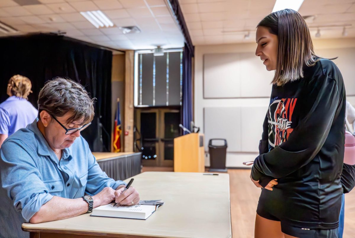 NE Author Skip Hollandsworth autographs his book "She Kills" for student Lauren Villarreal.