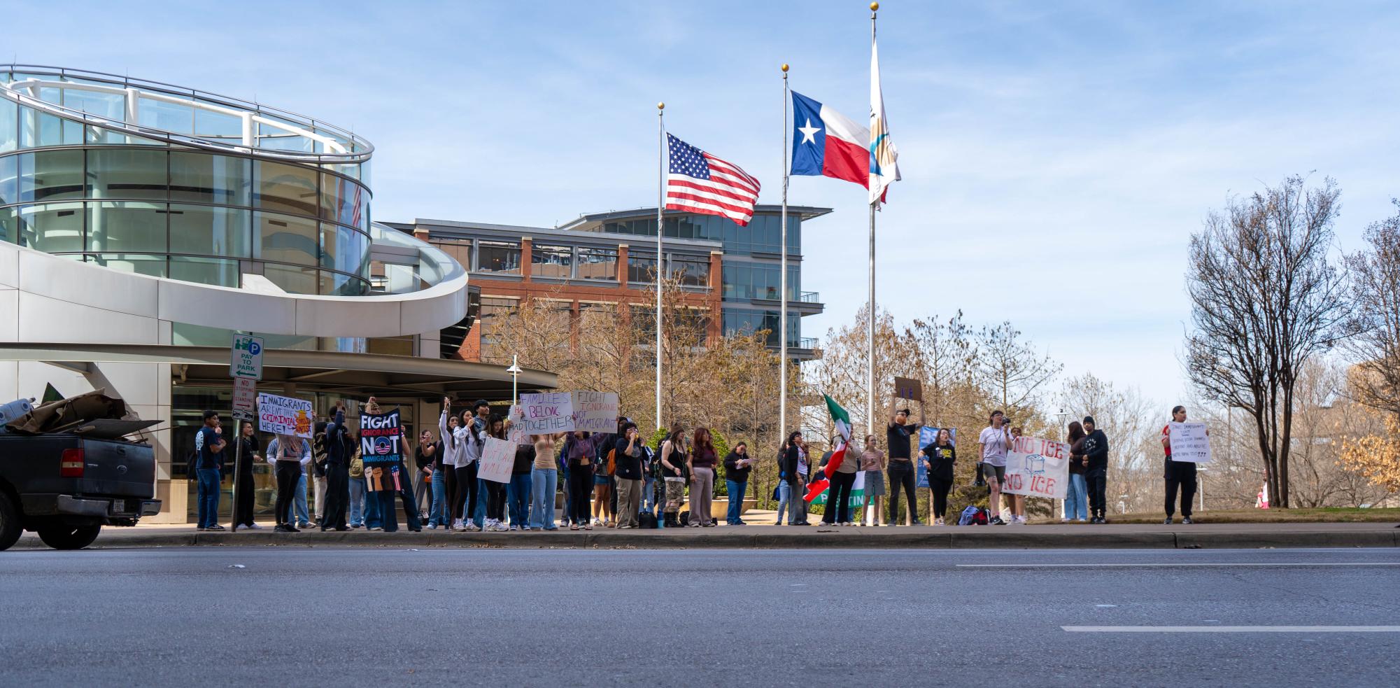 Students display signs to passing motorists on West Belknap Street during an ICE protest on TR Campus on Feb. 25.