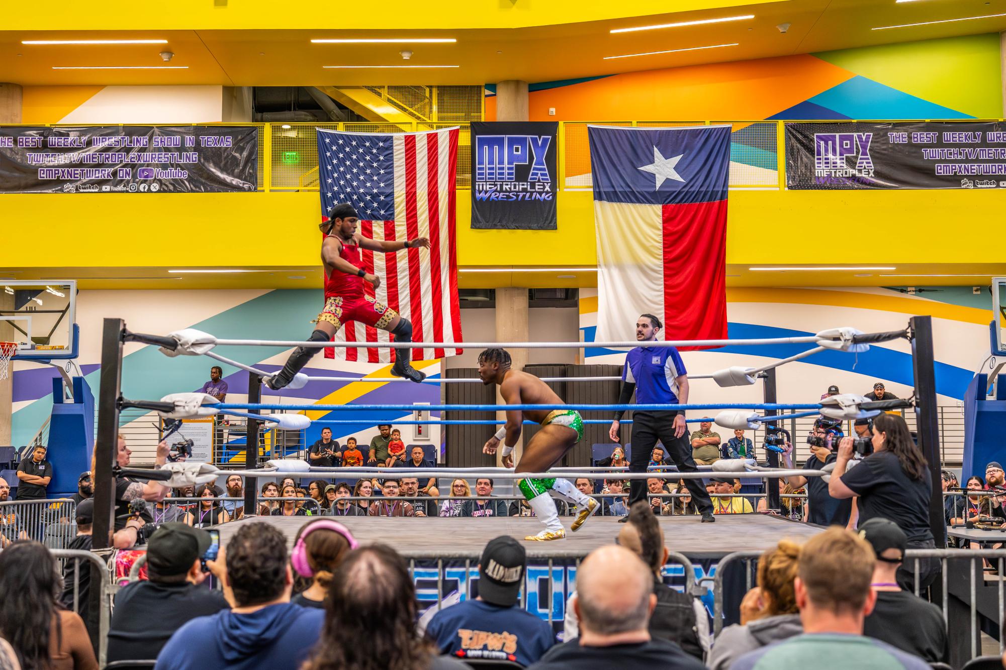 Professional wrestler “The Problem Child” performs an aerial technique against opponent LVJ during Metroplex Wrestling’s show 
called “Destiny” at The Epic in Grand Prairie on April 11. Two NE students worked on the production team for the event.