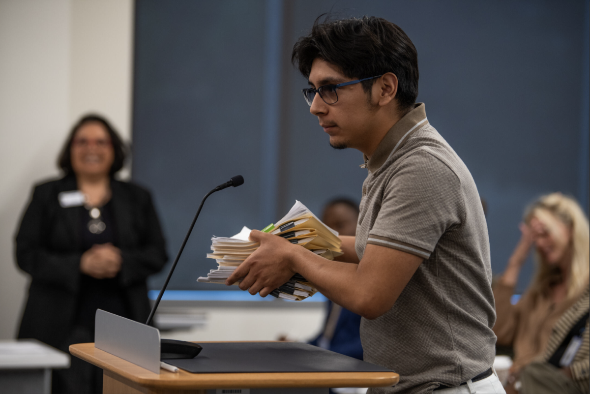 Student Josh Garcia presents petition 
to reinstate NE’s dance director.