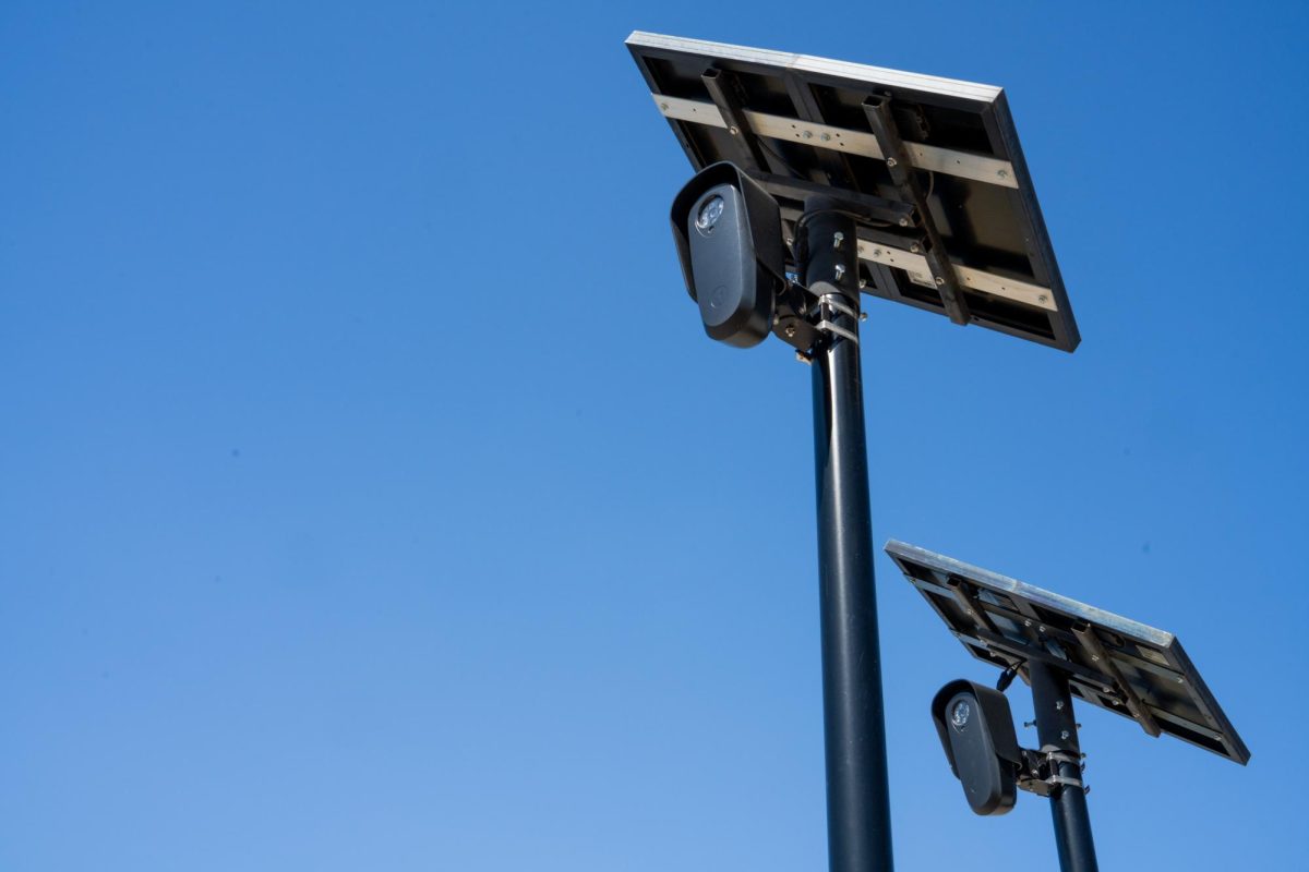 Flock cameras capture vehicle data on Harwood Road. 