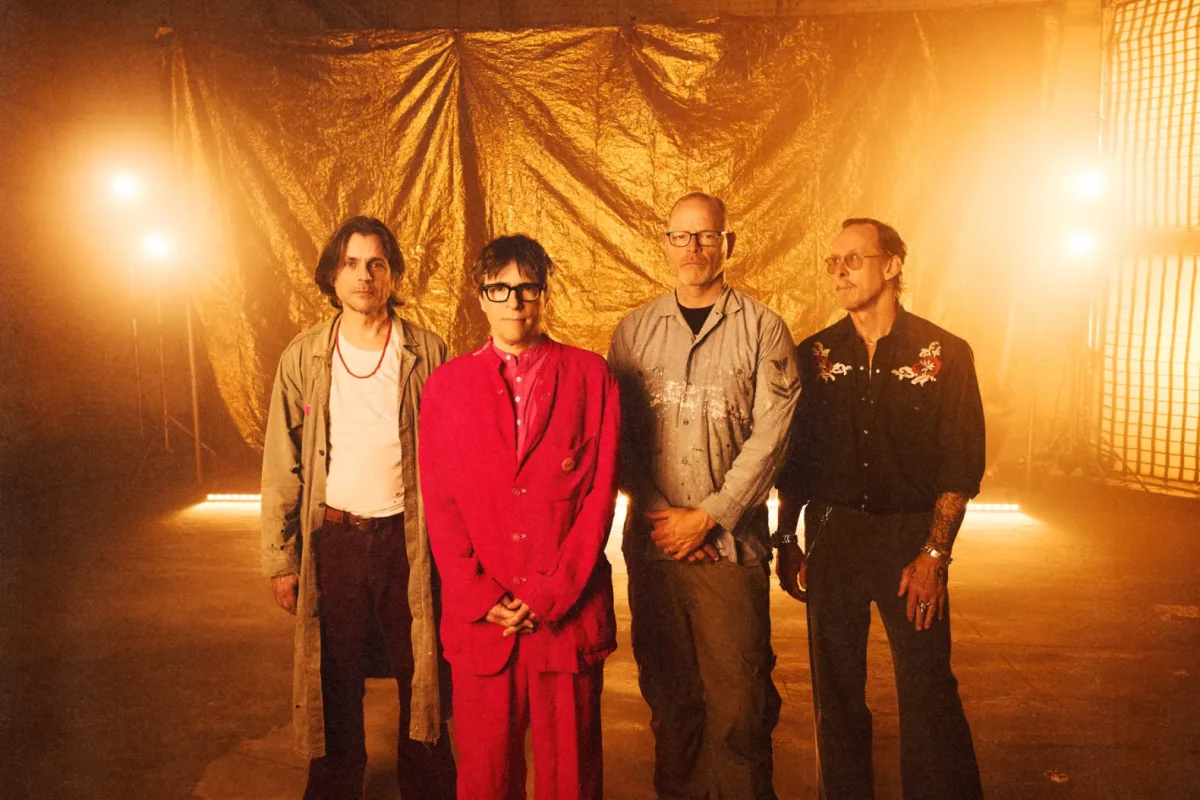 Members of the band Weezer stand in front of gold backdrop for photoshoot promoting their new album "The Gold Album," that released Aug. 21.