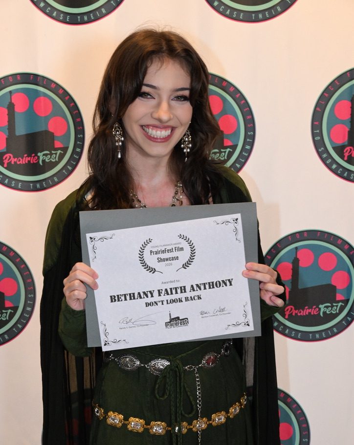 NE student Bethany Anthony receives the Young Filmmaker Award at the PrairieFest Film Showcase Aug. 29.