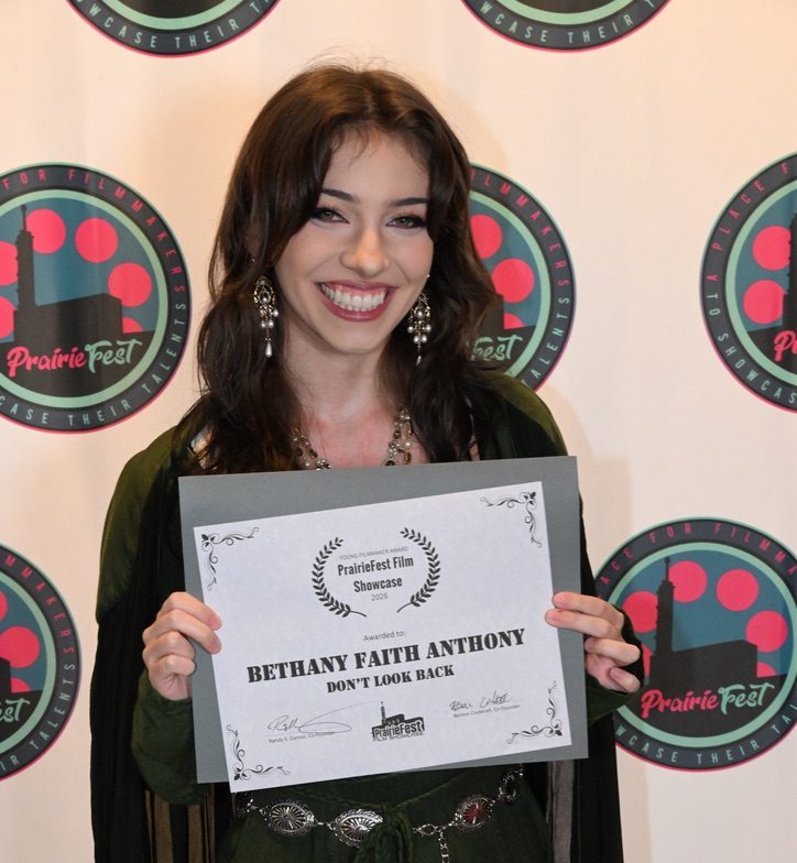 NE student Bethany Anthony receives the Young Filmmaker Award at the PrairieFest Film Showcase Aug. 29.