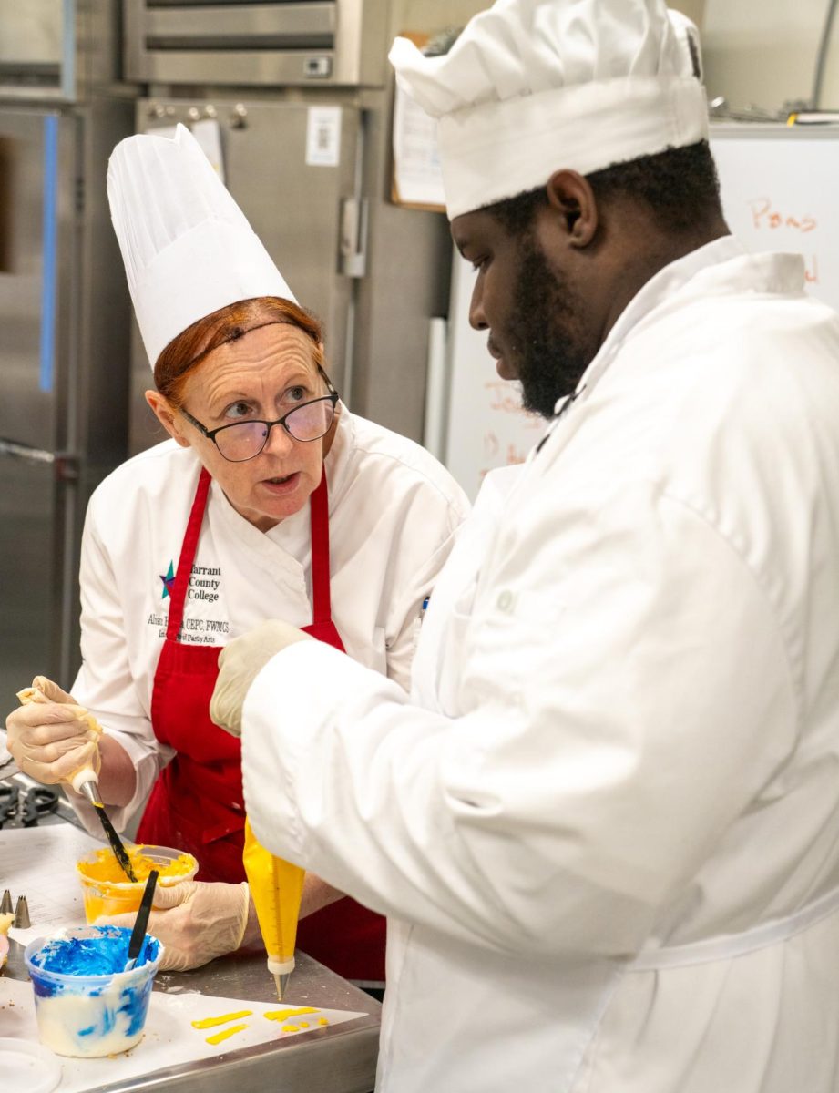 SE chef and instructor of culinary arts Alison Hodges assists student Chidi Izuwah Sept. 28.