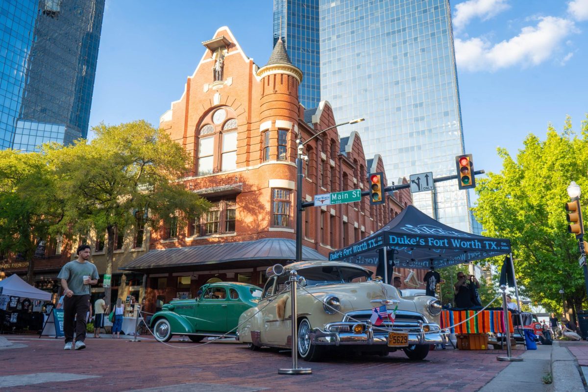 The Fort Worth chapter of Duke’s Car Club showcases a green 1938 Chevrolet and a cream 1951 Chevy Deluxe on Main Street at Sundance Square Sept. 6. The event on Sept. 19 will display 200 lowrider cars. 