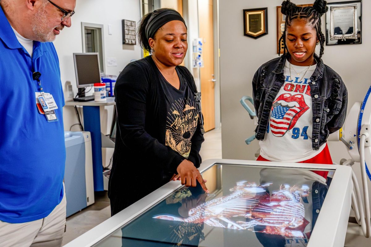 TR East student Jade Montague points to a diagnostic scan of conjoined twins Aug. 25.