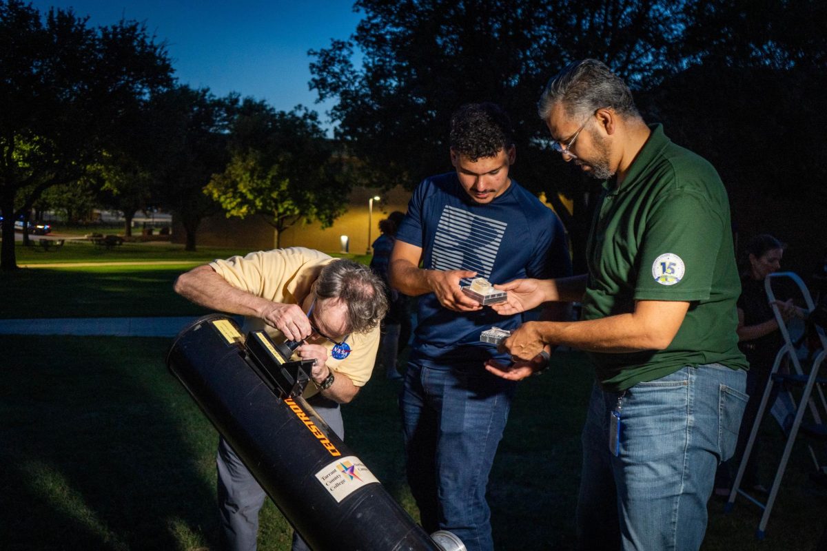 NE Professor Raymond Benge adjusts a Celestron telescope to focus on the Moon, while NE student Ibrahim Elbanna and associate professor Said Bakkar look at the Meteors on the Northeast Campus, Sept. 19.