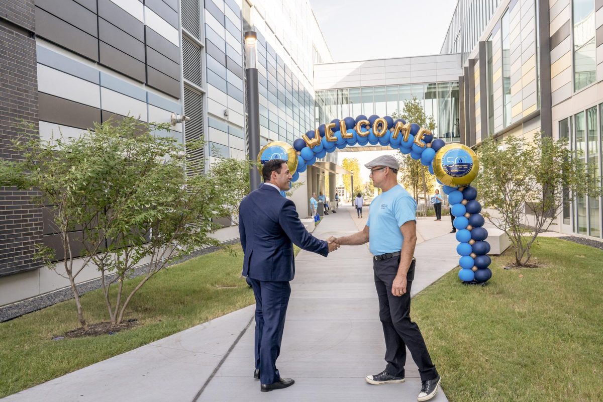 Cybersecurity department chair Greg Wise greets Tarrant County Commissioner Manny Ramirez at the 50th anniversary celebration of NW Campus Sept. 18. NW staff members welcome guests as they arrive.