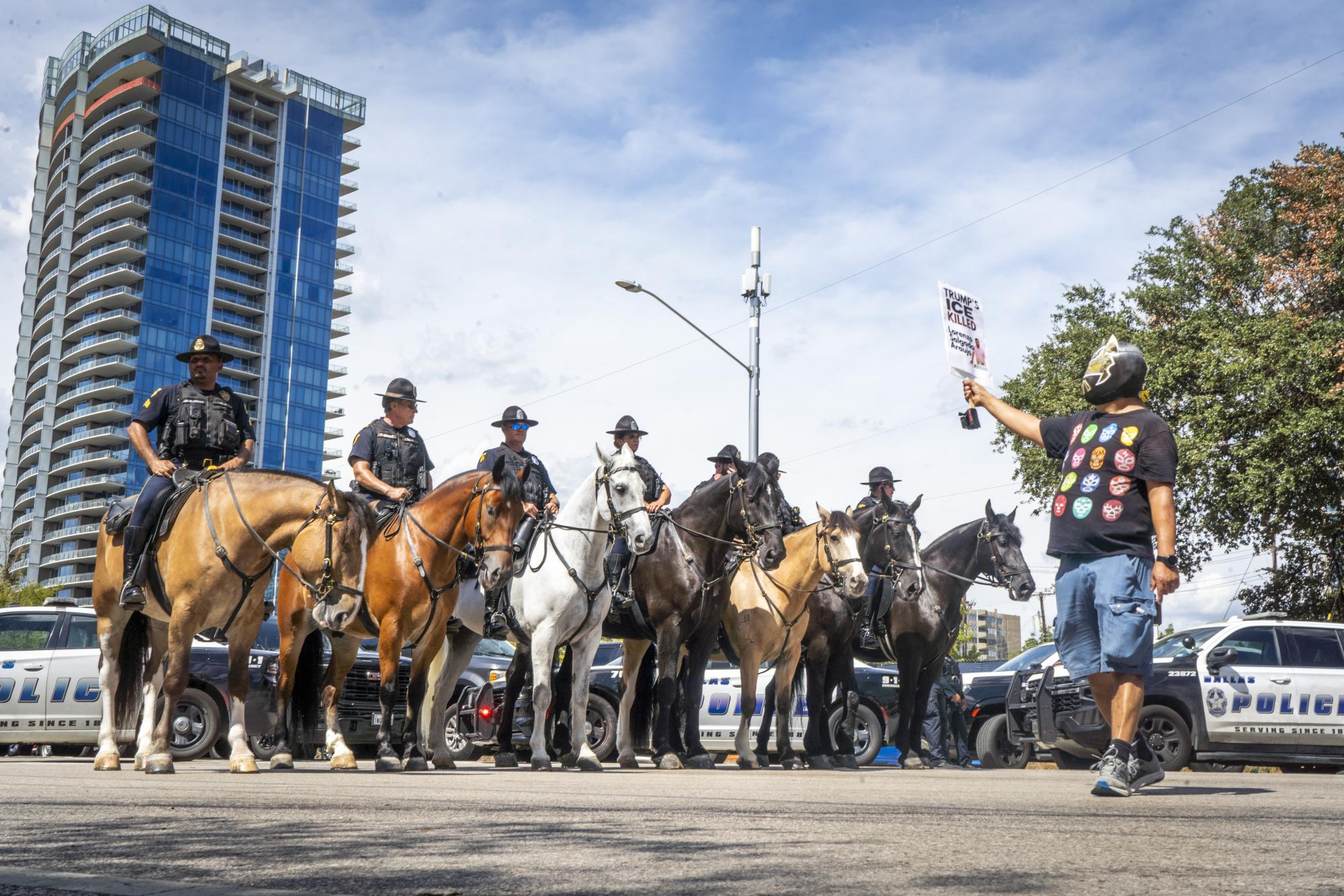 A masked protester confronts the Dallas Police Department Mounted Unit on Harry Hines Boulevard Sept. 10.