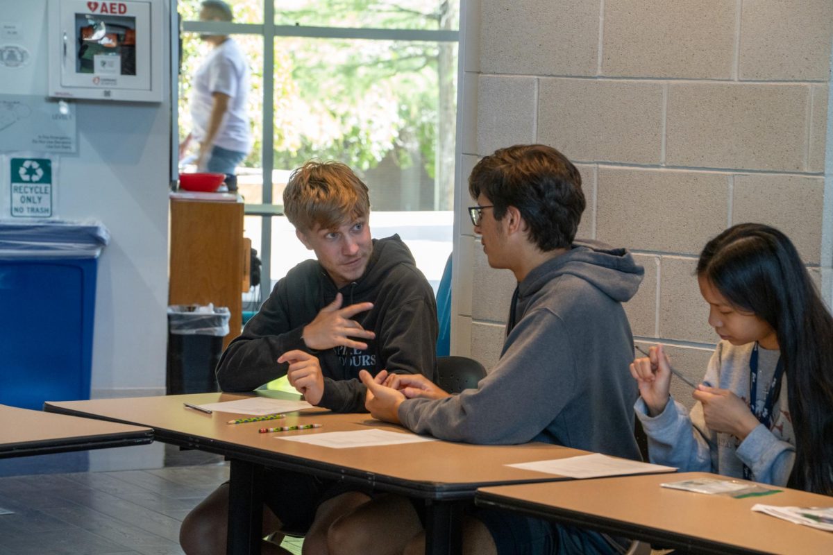 At TR during Deaf Deaf World event, Flower Mound High School students Ghirin Newton and Tristen Howard exchange American Sign Language signs Oct. 8. 