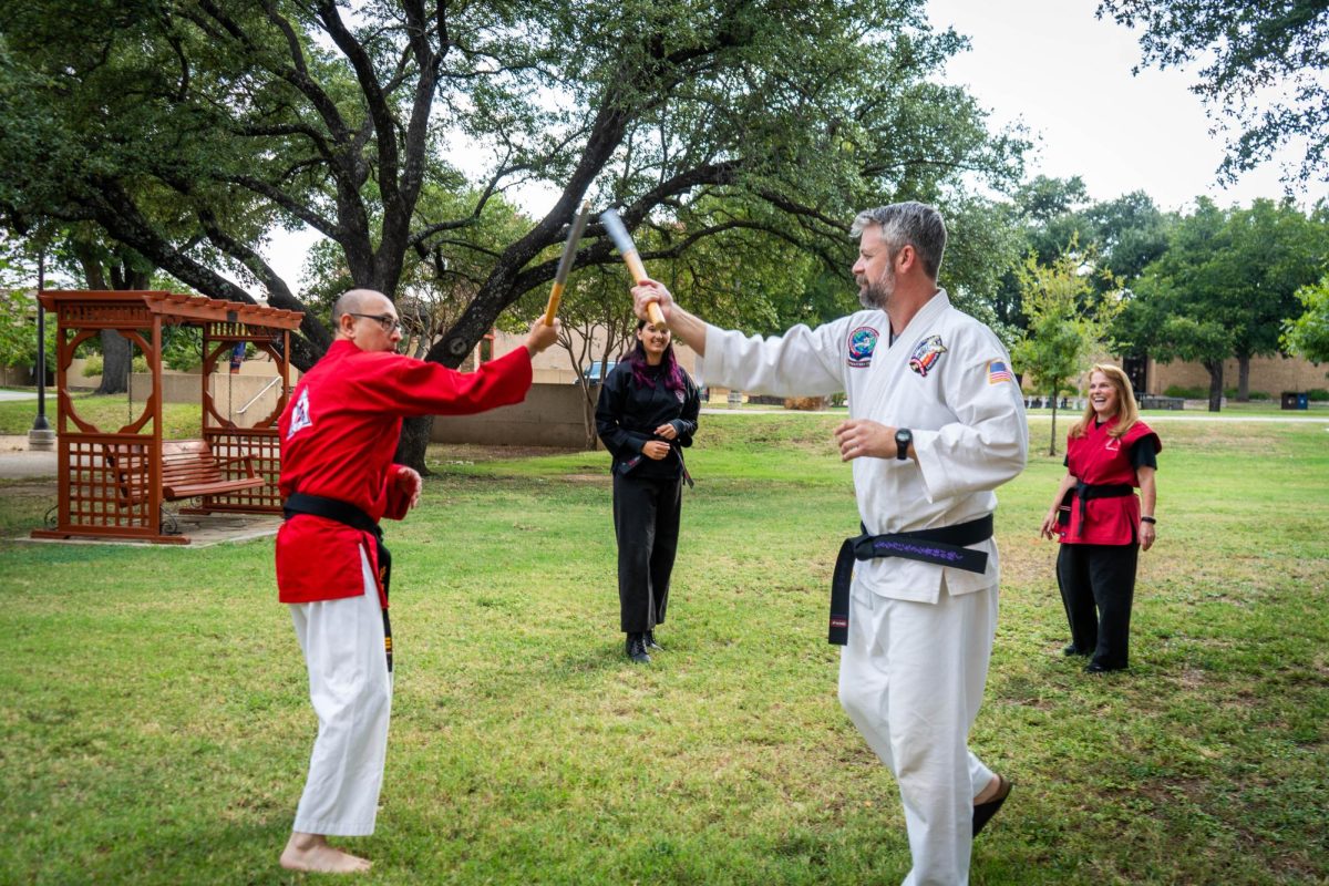 NE math assistant professor Joel Gutierrez and instructor Grant Griffin perform martial arts skills with escrima sticks used to 
teach striking, blocking and footwork Sept. 18 on NE Campus. 