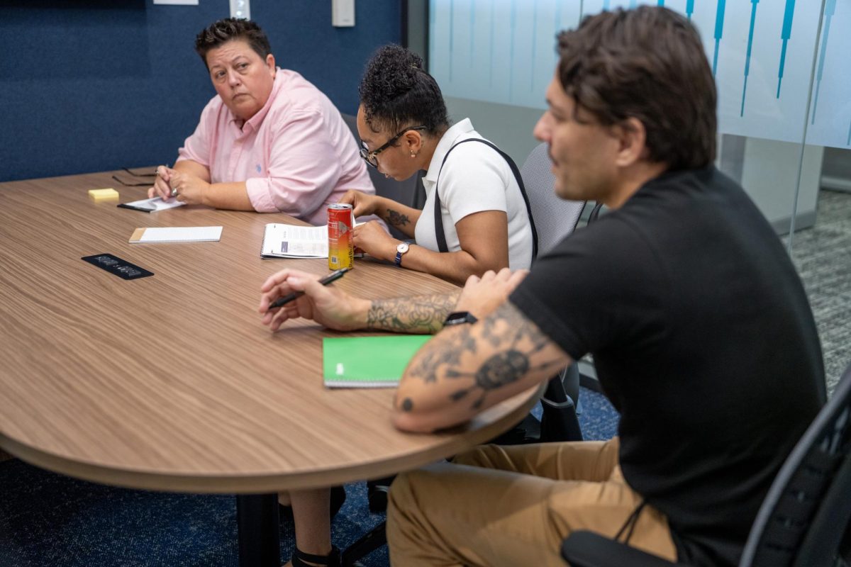 From left to right: SE assistant professor Yolanda Wright, student Debriana McLemore and assistant professor Martin Molina goes over draft pages from The Compass.