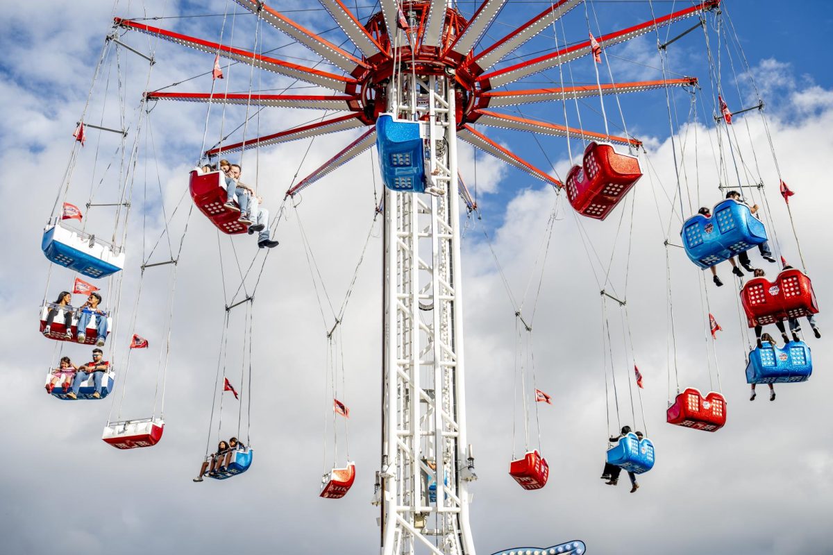 Fairgoers soar above the fairgrounds from the Thunderbird swing tower, the tallest portable swing ride in North America, Oct. 4 at the State Fair of Texas in Dallas. 
